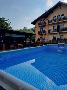 a large swimming pool in front of a building at Casa Dracula by Pro Lex in Bran