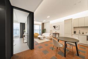 a kitchen and living room with a table and chairs at Le collective Siheung Wavepark in Siheung
