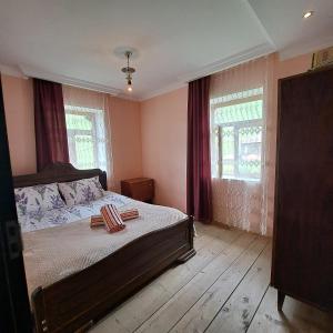 a bedroom with a bed with two pillows on it at Chvibiani Guesthouse & Bar in Ushguli