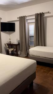 Postel nebo postele na pokoji v ubytování Hotel Maquis et Mer