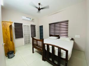 a bedroom with a bed and a ceiling fan at JOSEPH'S HOMESTAY in Fort Kochi