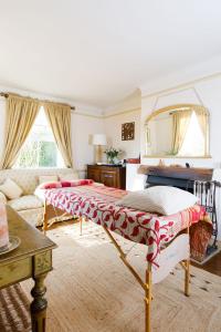 a living room with two beds and a mirror at Woodfield Wellbeing in Oving