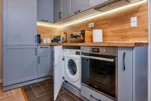 a kitchen with a washer and dryer in it at Florance Rentals Luxury Apartments in Saint Vlas in Sveti Vlas