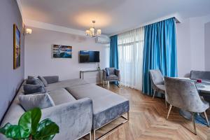 a living room with a bed and a dining room at Florance Rentals Luxury Apartments in Saint Vlas in Sveti Vlas