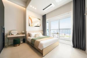 a bedroom with a bed and a large window at Le collective Siheung Wavepark in Siheung