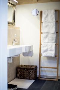 a bathroom with a sink and a shelf with towels at Châlets de la Liberté B in Oberstaufen +50 photos
