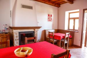 a living room with a table and a fireplace at Katica Vendégház in Tarcal