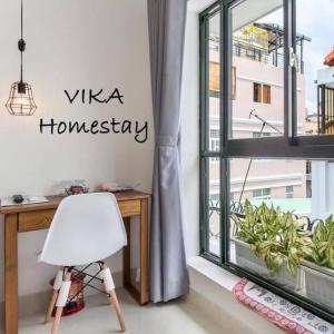 een witte stoel voor een raam bij Vika Homestay in Ho Chi Minh-stad