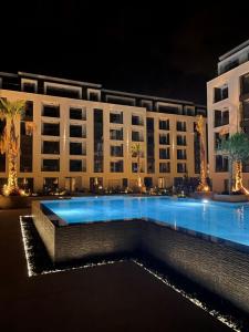 a large building with a swimming pool at night at SUNNY STUDIO AZUR in Saints Constantine and Helena