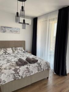 a bedroom with a bed with two pillows and a window at SUNNY STUDIO AZUR in Saints Constantine and Helena +30 photos