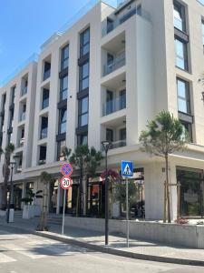 a large white building with street signs in front of it at SUNNY STUDIO AZUR in Saints Constantine and Helena