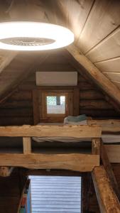 a room with two bunk beds in a wooden cabin at Uneallika hubane saunaga majake "Hoburaud" in Pae