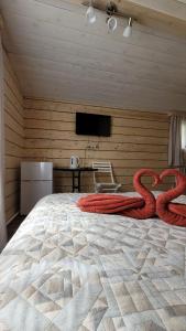 a bedroom with a large bed with two snakes on it at Guest House Firebird in Belokurikha