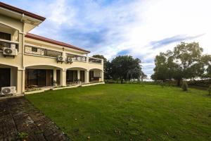 a house with a large yard in front of it at The Suites @ Bellavista in Isabel