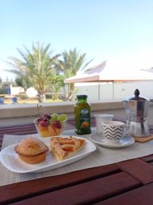 a table with a plate of breakfast food on it at Villa Alfea CAMERE in Porto Cesareo