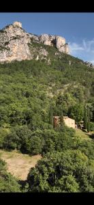 a large mountain with a house on top of it at Domaine d'Angouire in Moustiers-Sainte-Marie