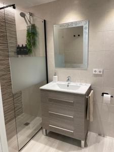 a bathroom with a sink and a shower at Apartamento Arena Benidorm in Benidorm