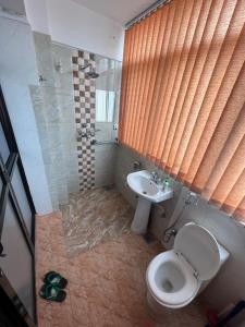 a bathroom with a toilet and a sink at The Boudha Inn in Kathmandu