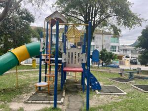 a playground with a slide in a park at Homestay Raudhah, Taman Gombak Ria in Batu Caves