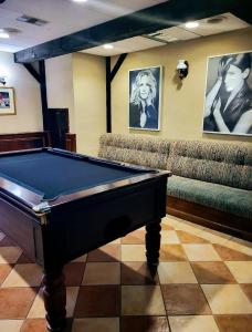 a pool table in a room with couches at The San Anton Hotel in St. Paul's Bay