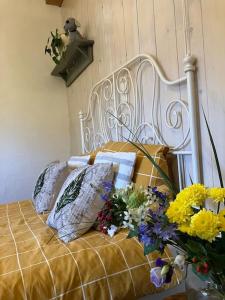 a white bed with a bunch of flowers on it at The Tiny Garage in Kampen