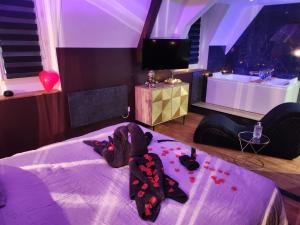 a room with a stuffed animal on a bed at Caen, Tu m'aimes - Suite Romantique in Caen