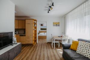 a living room with a couch and a table at Ferienwohnung Illy in Illmitz