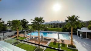 a swimming pool with palm trees on top of a building at Villa Botanica-Exclusive 8-Bedroom Villa by Luxury Explorers' Collection in Dubai