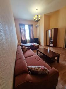 a living room with a couch and a table at Piano Hotel in Tbilisi City