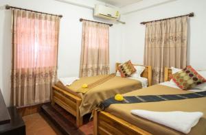 Postel nebo postele na pokoji v ubytování Nammavong Guesthouse + 8 fotografií