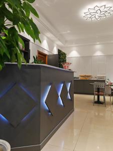a kitchen with a counter with blue lights on it at Hotel Romano in Turin