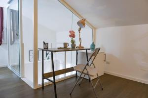 a desk and chair in a room with a window at Italstay - Disciplini Duplex - 10 min dal Duomo in Milan
