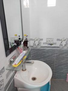 a bathroom with a white toilet and a sink at HomeStay Ông Vinh 