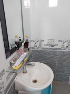 a bathroom with a white toilet and a sink at HomeStay Ông Vinh in Lệ Thủy