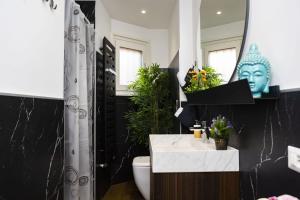 a bathroom with a toilet and a sink and a mirror at Italstay - Disciplini Duplex - 10 min dal Duomo in Milan