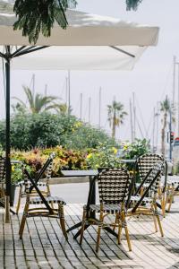 - un groupe de chaises et une table avec un parasol dans l'établissement Casa Alberola Apartments, à Alicante
