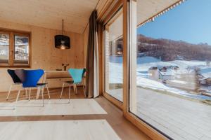 a room with two chairs and a large window at Haus W in Schruns
