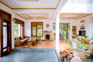 a living room with a couch and a fireplace at Green Hill Ba Vi Venuestay in Ba Vì