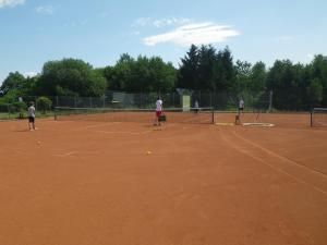 a group of people playing tennis on a tennis court at Ferienhaus Freilingen 184 in Blankenheim