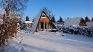 a small cabin in the snow with snow covered ground at Ferienhaus Freilingen in Blankenheim