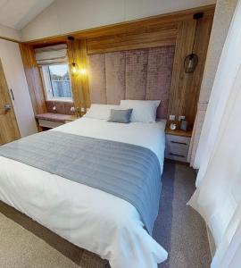 a bedroom with a large white bed in it at Presthaven Resort Haven Luxury 2023 Caravan in Prestatyn