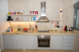 a kitchen with a counter with a sink and a stove at Beach Villa Next To The Waves! in Istiaía