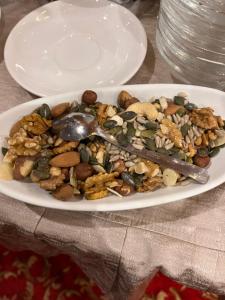a plate of food with nuts on a table at Hotel Teco in Milan