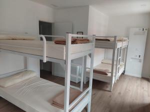 a room with three bunk beds in a room at ALBERGUE CASTELOS in Lorenzana