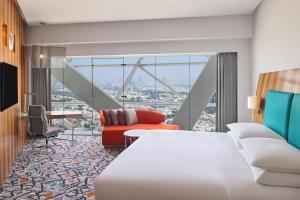 a hotel room with a bed and a desk at Andaz Capital Gate Abu Dhabi - a concept by Hyatt in Abu Dhabi
