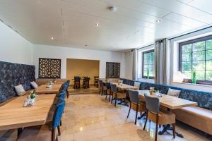 a dining room with wooden tables and chairs at Hotel Franken in Forchheim