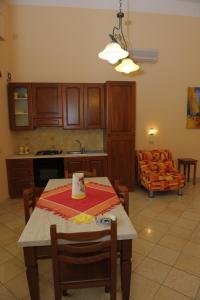 クストナーチにあるil Giardino degli Agrumiのキッチン、リビングルーム(テーブル、椅子付)