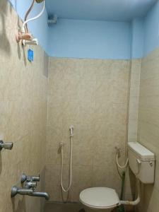 a bathroom with a toilet and a shower at Hotel Blue Coral Rameswaram in Rāmeswaram +30 photos