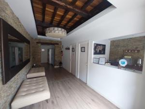 a hallway with two benches in a room with a ceiling at ALBERGUE CASTELOS in Lorenzana