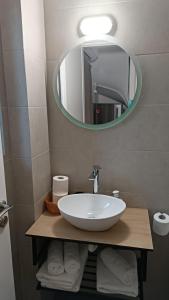 a bathroom with a white sink and a mirror at Pagani Green - Luxury Maisonette I2 in Kalamata